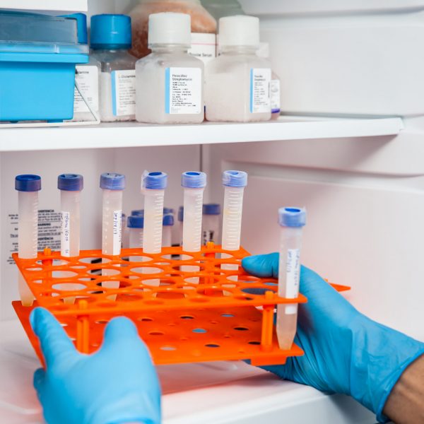 Young male scientist and laboratory freezer